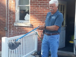 Dan Crider from D and R Pest Control removes the unwanted visitor from the KSLQ/KWMO Studios.